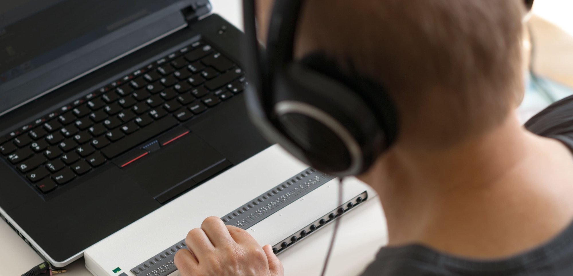 Person using accessible laptop 